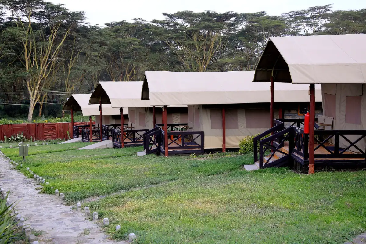 Row of permanent tented rooms with porches at a lakeside camp in Naivasha